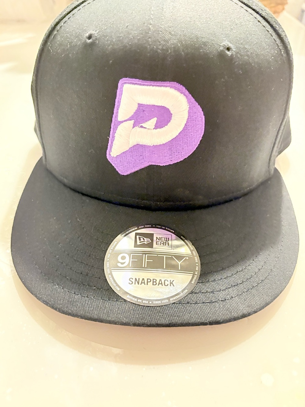 New Era Black Snapback Hat with Purple & White Patch